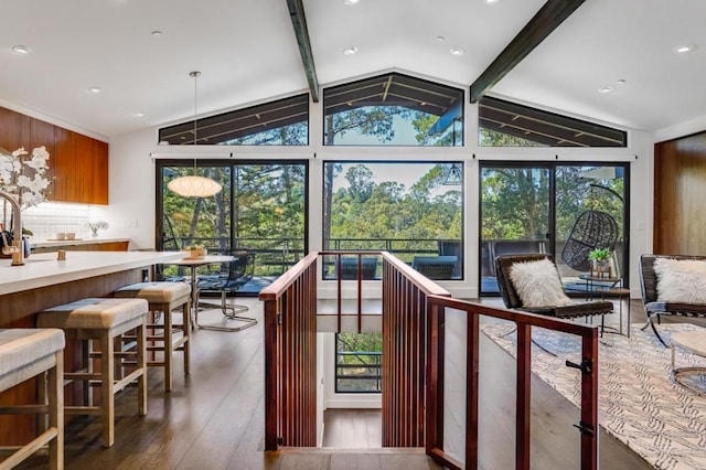 sunroom with lofted ceiling with beams