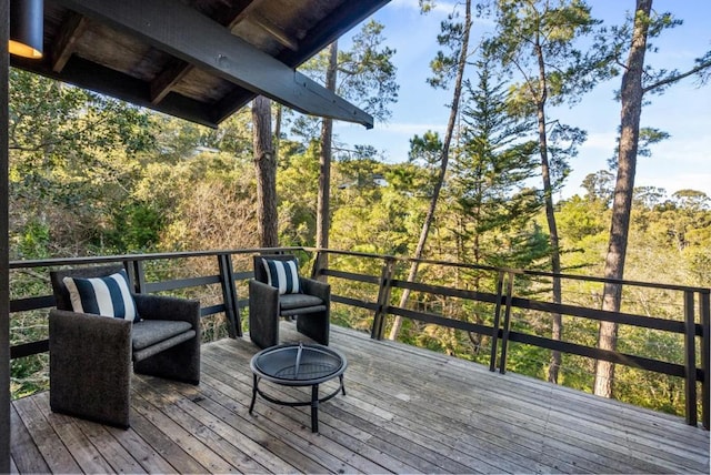 wooden terrace with a fire pit