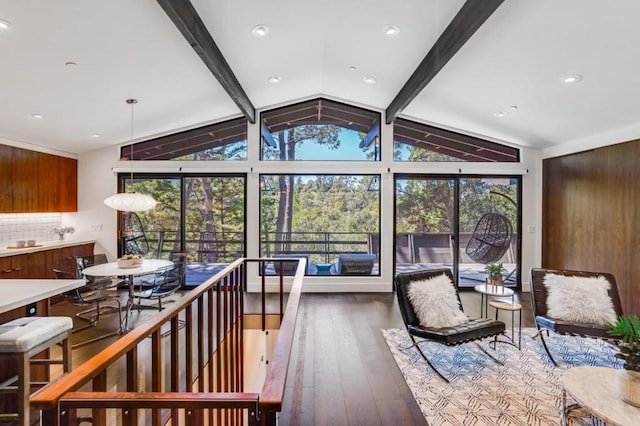 sunroom with lofted ceiling with beams