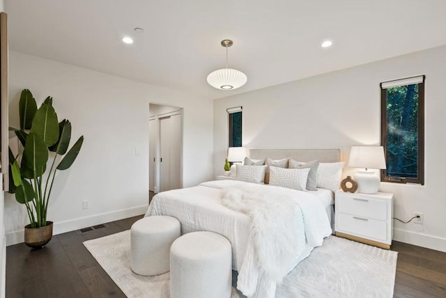 bedroom with dark wood-type flooring