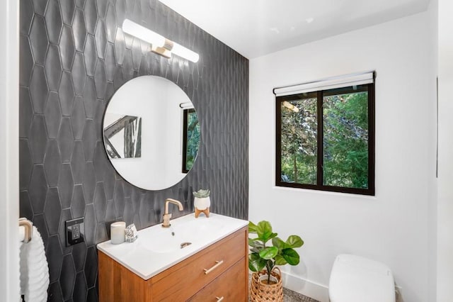 bathroom featuring vanity and tile walls