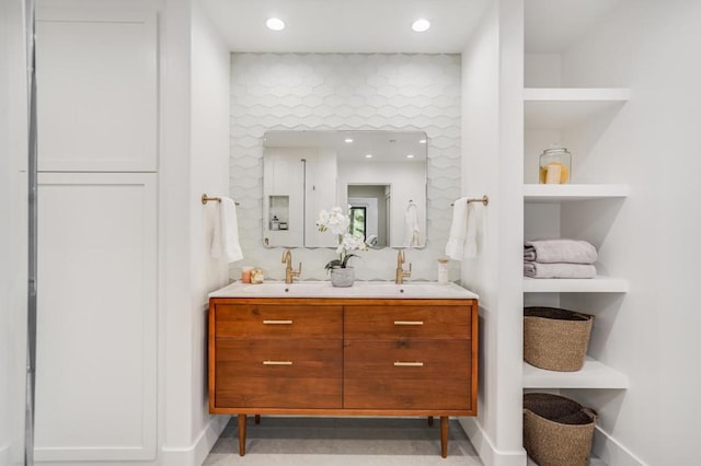 bathroom featuring built in shelves and vanity