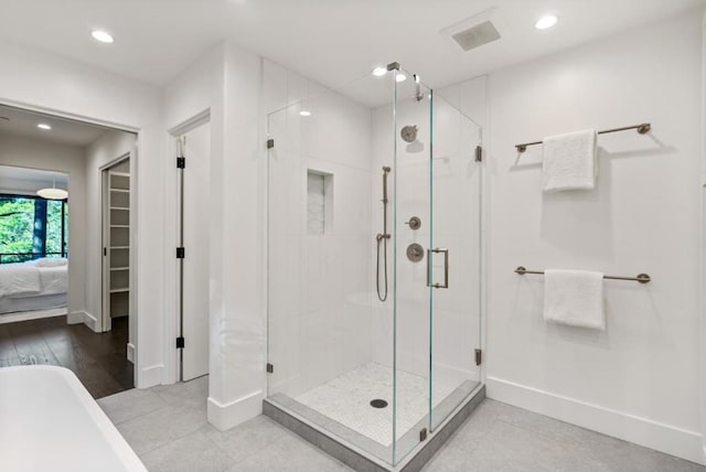 bathroom featuring independent shower and bath