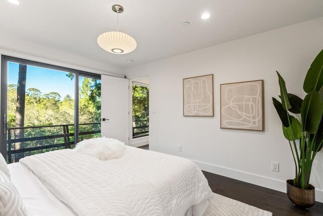 bedroom with dark hardwood / wood-style flooring