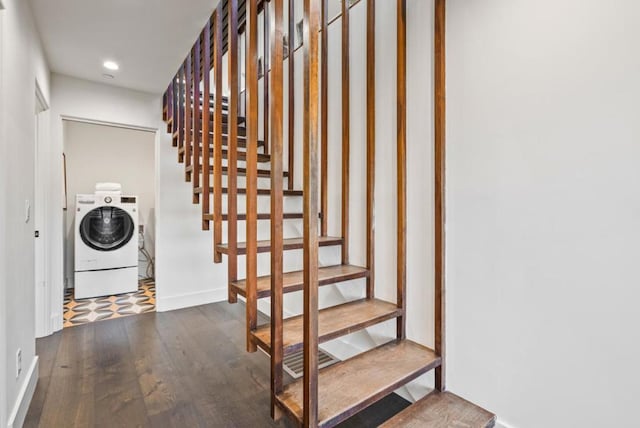 stairway featuring washer / dryer and hardwood / wood-style floors