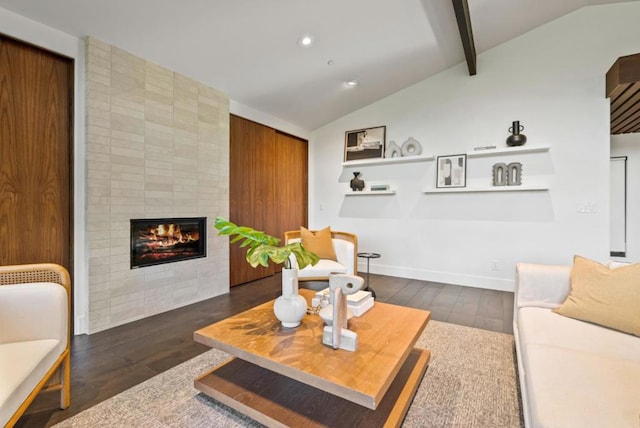 living room with lofted ceiling with beams, dark hardwood / wood-style flooring, and a fireplace