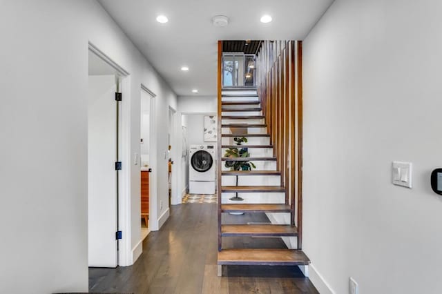 staircase featuring washer / clothes dryer and hardwood / wood-style flooring