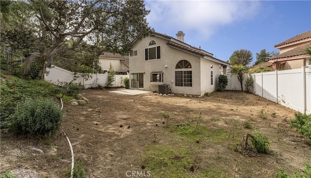 rear view of property with a patio and central AC unit