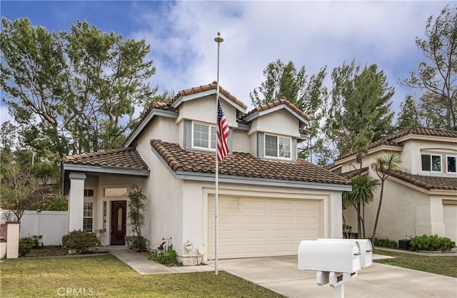 mediterranean / spanish-style house with a garage and a front yard