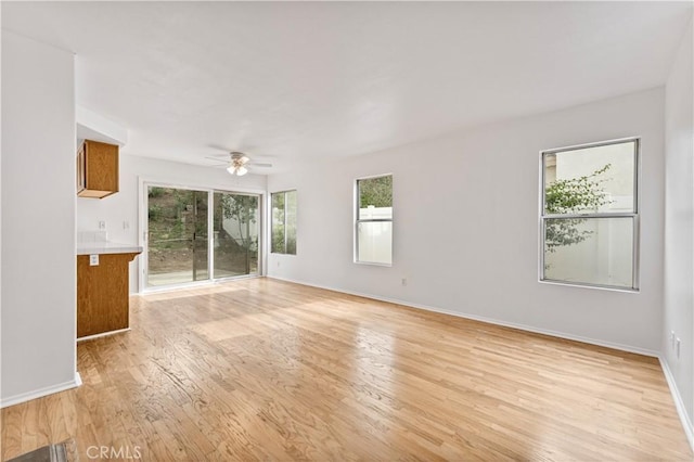 unfurnished living room with light hardwood / wood-style floors and ceiling fan