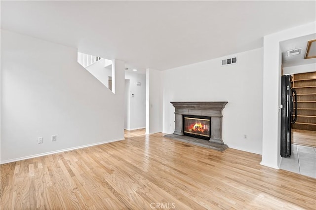 unfurnished living room with light hardwood / wood-style floors