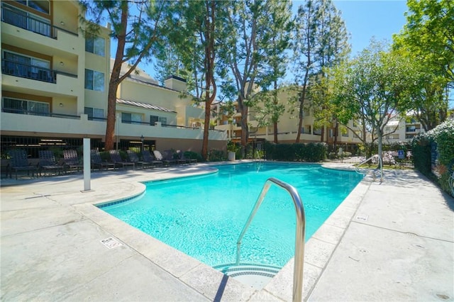 view of swimming pool with a patio