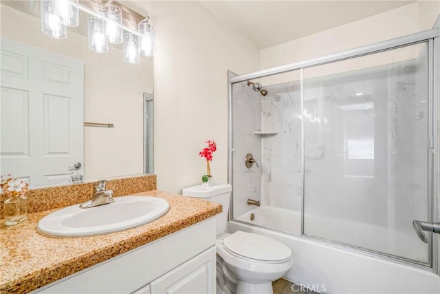 full bathroom with vanity, enclosed tub / shower combo, and toilet