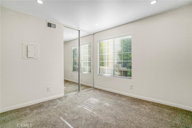 unfurnished bedroom with carpet flooring and a closet