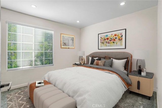 bedroom featuring multiple windows and dark colored carpet