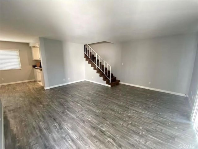 unfurnished living room featuring dark wood-type flooring