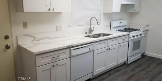 kitchen with sink, dark hardwood / wood-style flooring, white appliances, light stone countertops, and white cabinets