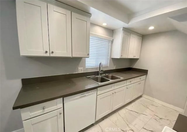 kitchen with white cabinetry, white dishwasher, and sink