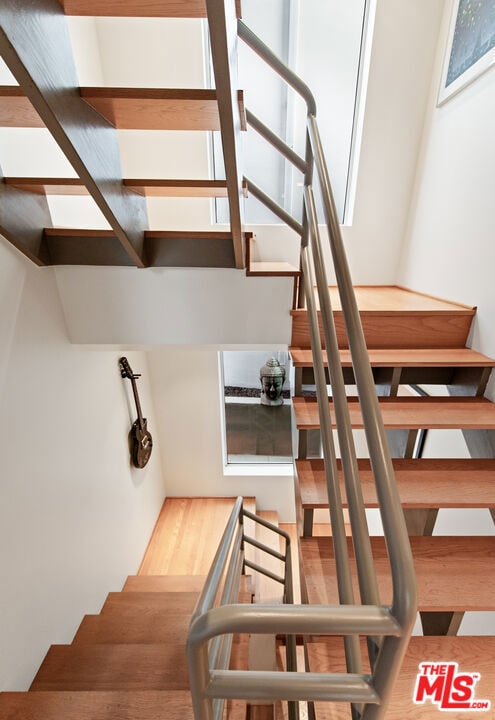 stairway with hardwood / wood-style flooring