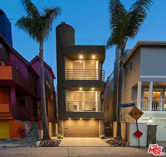 view of front of house with a garage and a balcony