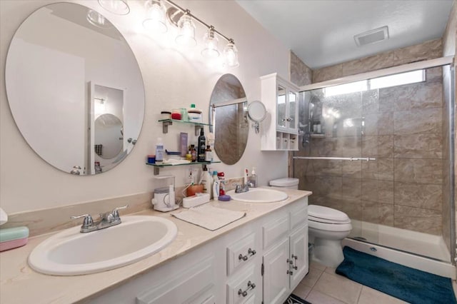 bathroom featuring vanity, toilet, tile patterned floors, and an enclosed shower