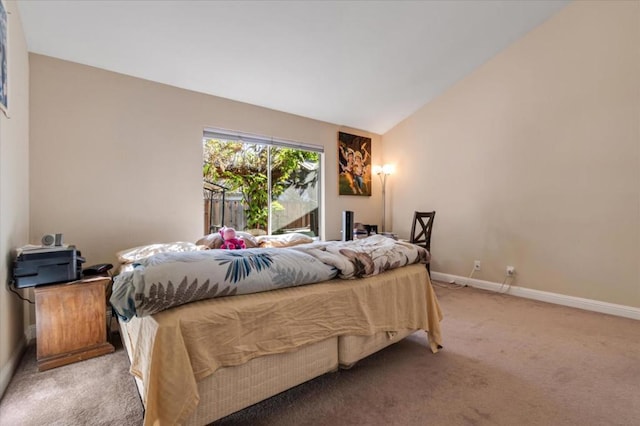 carpeted bedroom with lofted ceiling