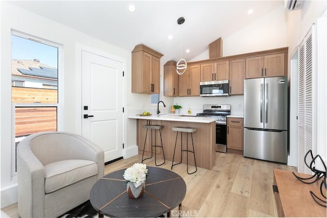 kitchen with a breakfast bar area, stainless steel appliances, decorative light fixtures, vaulted ceiling, and kitchen peninsula