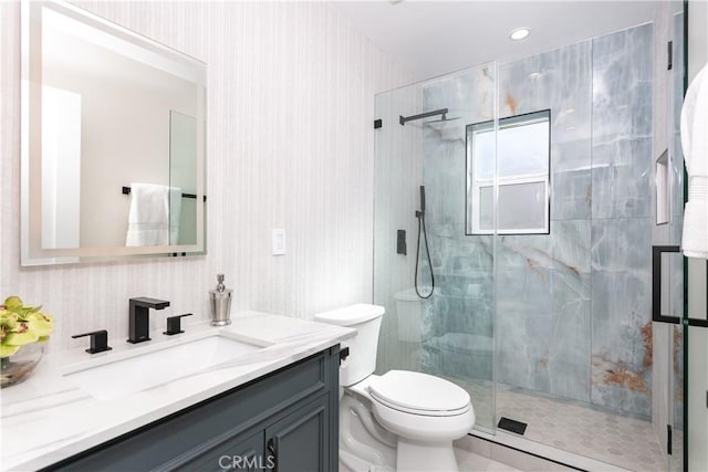 bathroom featuring toilet, an enclosed shower, and vanity