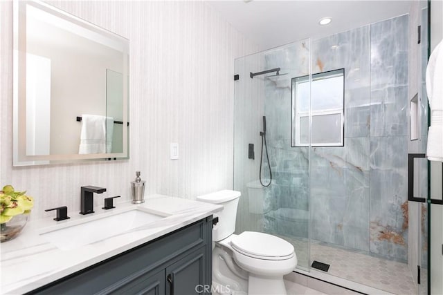 bathroom featuring vanity, toilet, and a shower with door