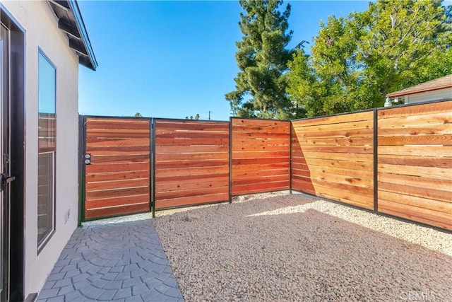 view of gate featuring a patio area