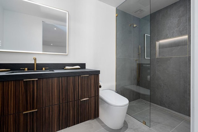 bathroom featuring tile patterned floors, toilet, vanity, and tiled shower