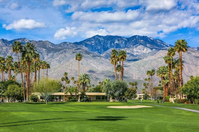 view of community featuring a mountain view and a lawn