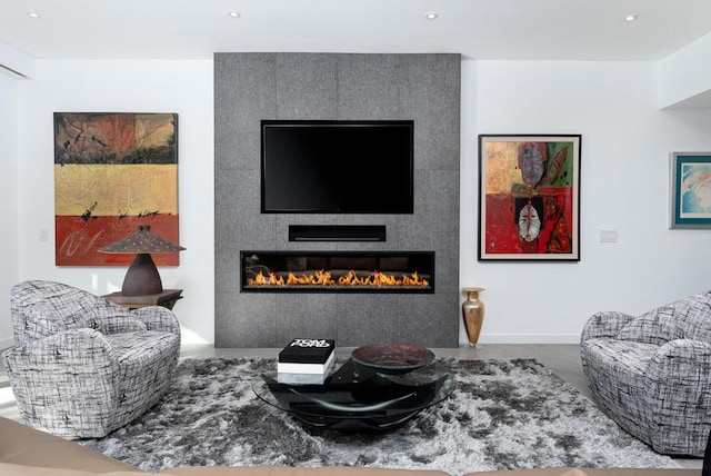 living room featuring a fireplace and concrete flooring