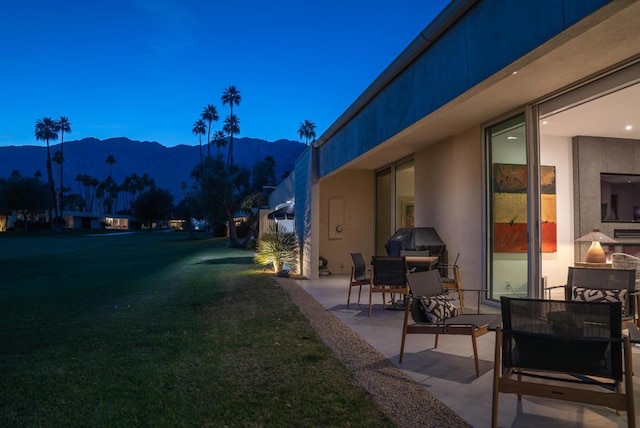 view of yard with a mountain view and a patio