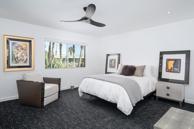 bedroom with dark colored carpet and ceiling fan