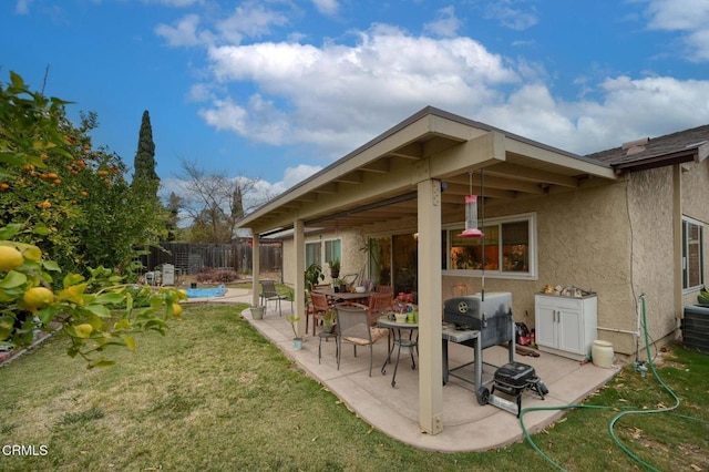 rear view of property with a pool, a yard, and a patio area