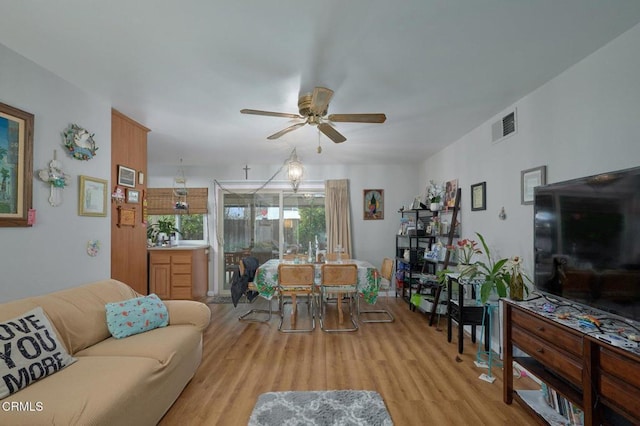 living room featuring ceiling fan and light wood-type flooring