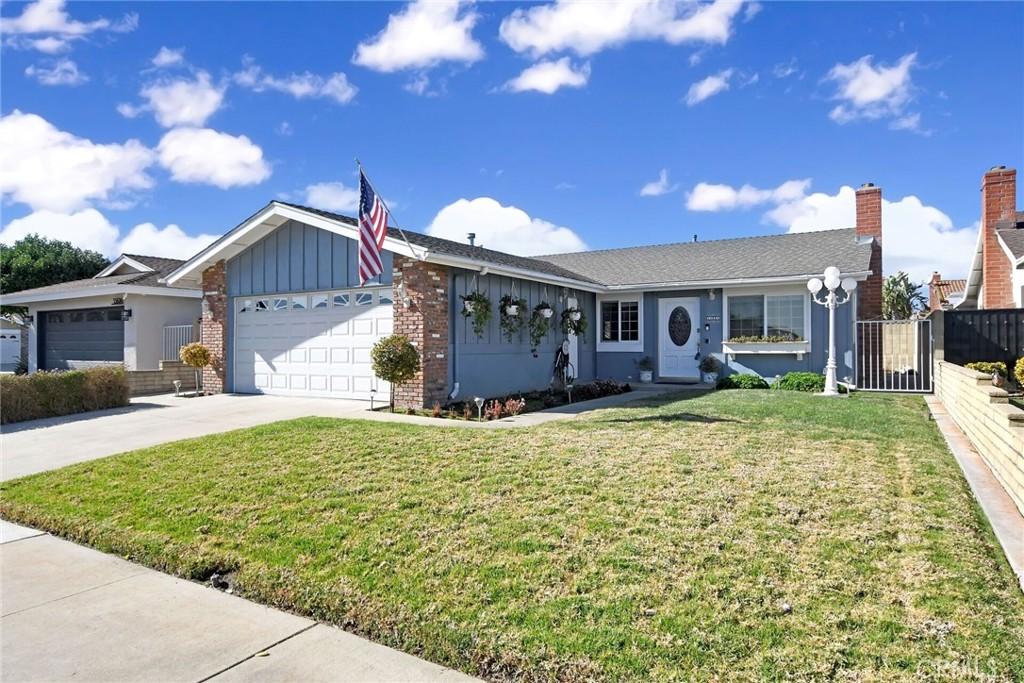 single story home with a garage and a front yard