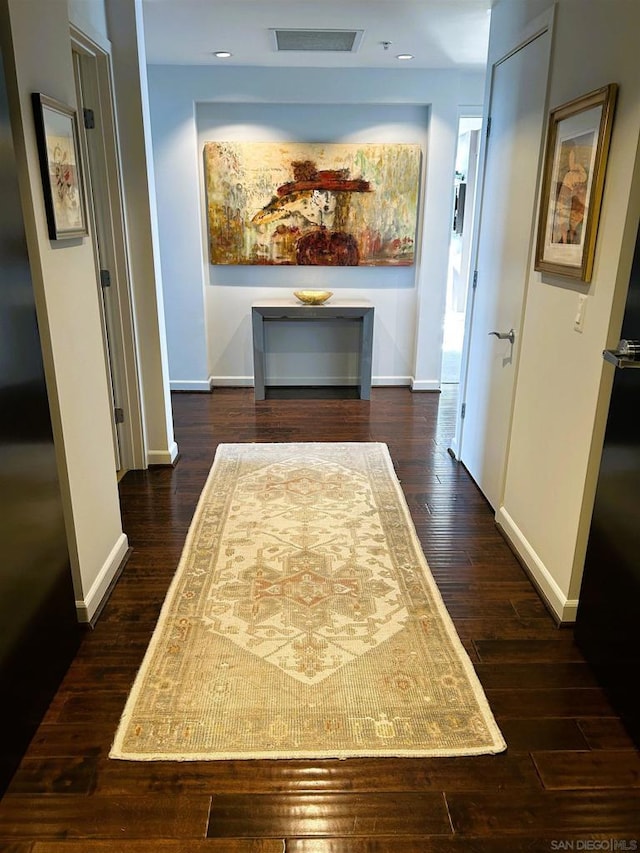 hallway with dark hardwood / wood-style floors