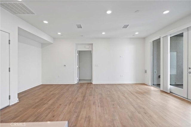 spare room featuring light hardwood / wood-style floors