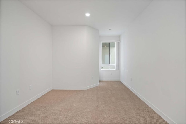 spare room with light colored carpet