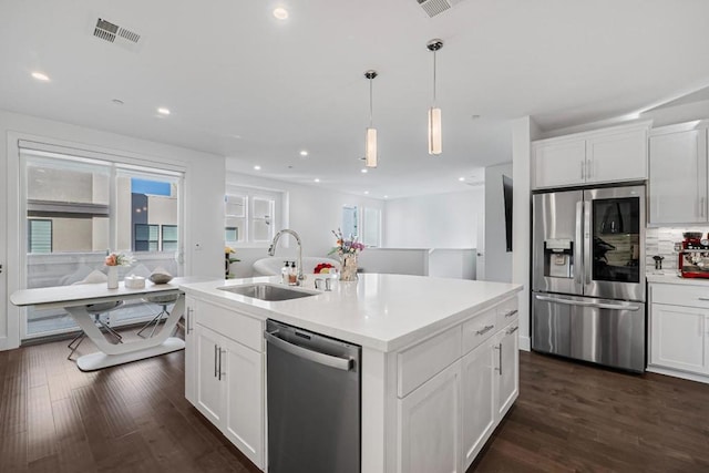 kitchen featuring appliances with stainless steel finishes, sink, and white cabinets