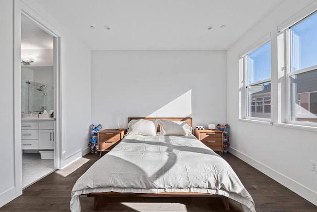 bedroom with dark hardwood / wood-style floors and ensuite bathroom