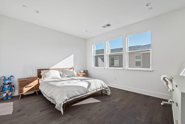 bedroom with dark wood-type flooring