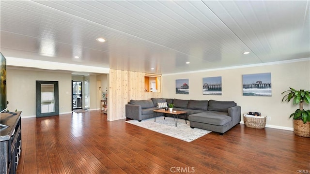 living room with dark hardwood / wood-style flooring, wood ceiling, and ornamental molding