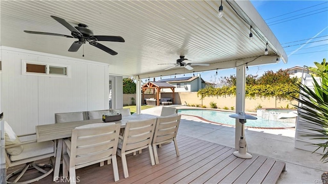 deck featuring a fenced in pool, a patio, a gazebo, and ceiling fan