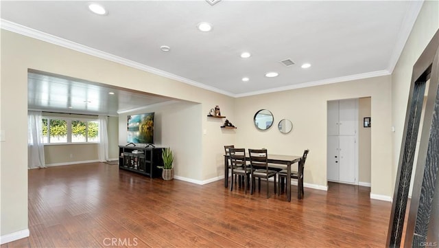 dining area featuring crown molding and wood-type flooring