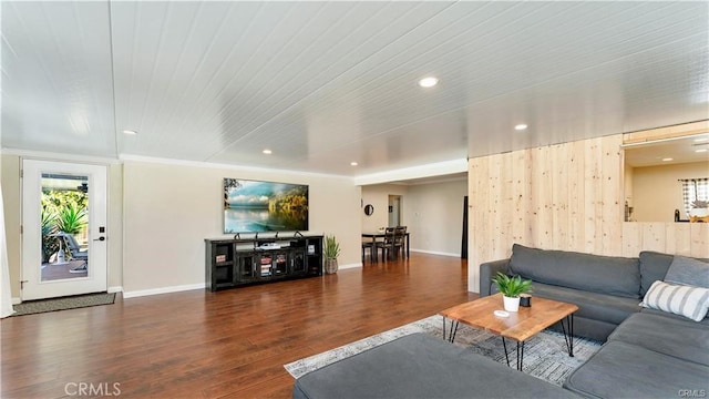 living room featuring ornamental molding and dark hardwood / wood-style flooring