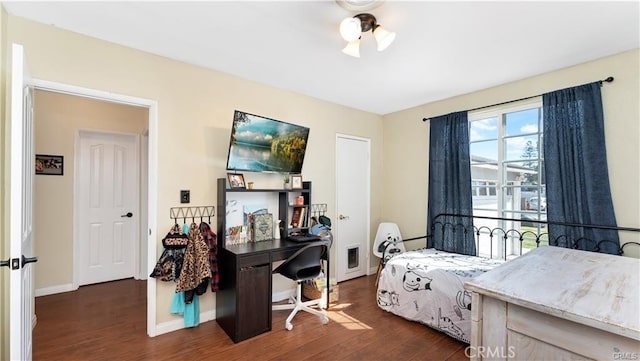 bedroom with dark hardwood / wood-style floors