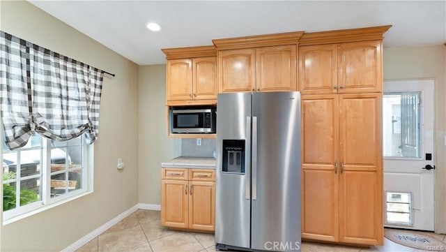 kitchen with light tile patterned floors and appliances with stainless steel finishes